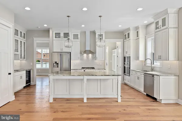 a large kitchen with cabinets and wooden floor
