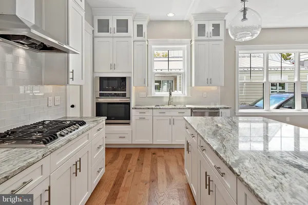 a kitchen with stainless steel appliances granite countertop a stove and a sink