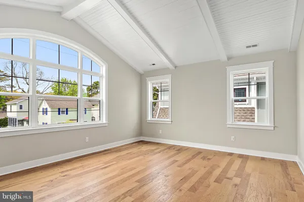 a view of an empty room and wooden floor