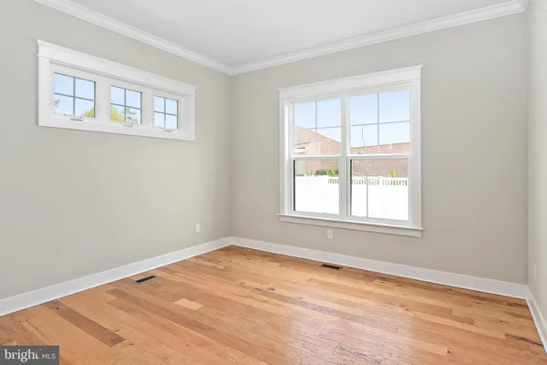 an empty room with closet and wooden floor