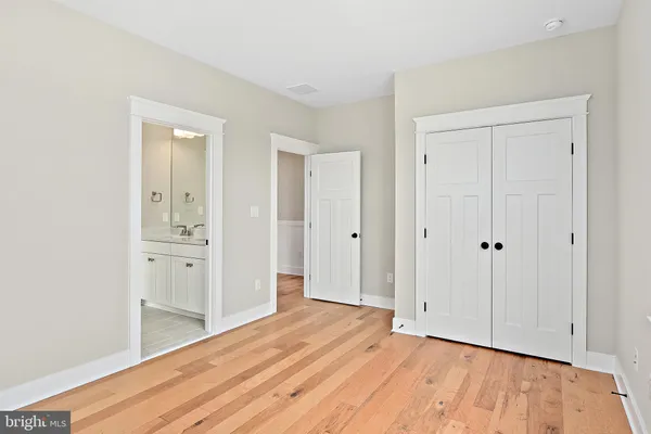 a view of a room with wooden floor