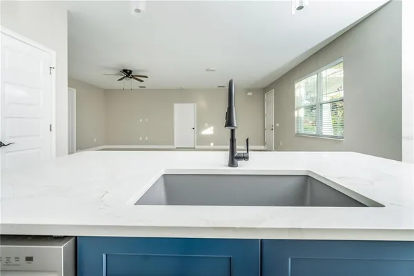 a view of a kitchen counter a sink and dishwasher with wooden floor