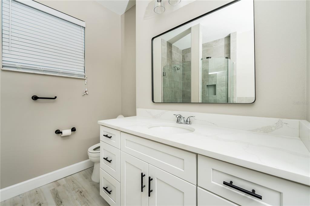 1011 Johnston Road Southeast Palm Bay, FL 32909 - Photo 19 of 47 a bathroom with a sink and a mirror