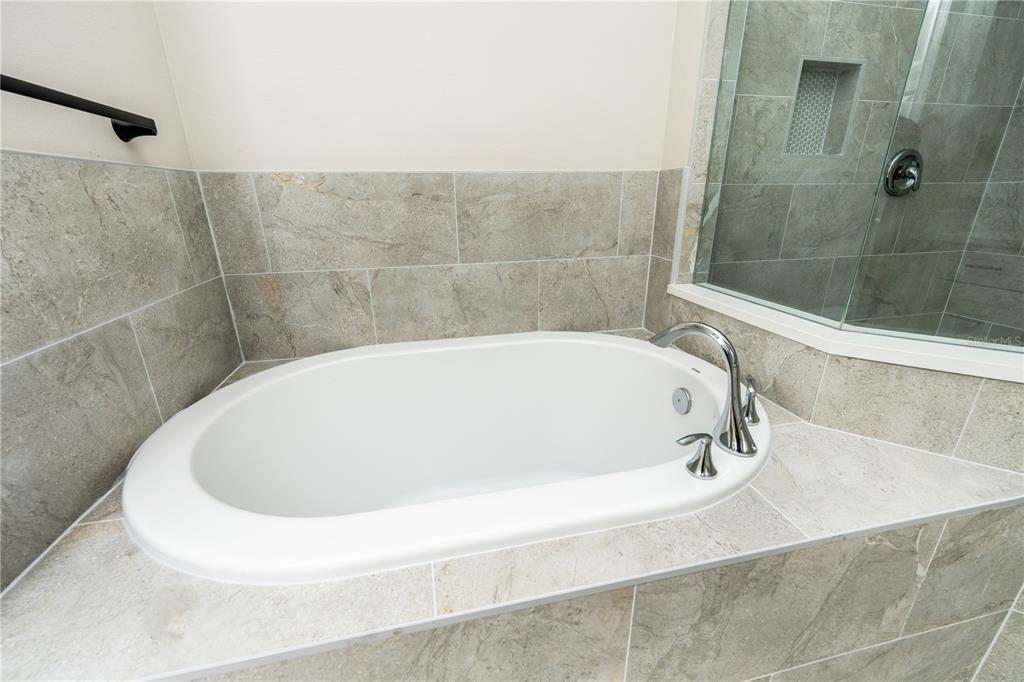 1011 Johnston Road Southeast Palm Bay, FL 32909 - Photo 20 of 47 a white bath tub sitting in a bathroom and shower