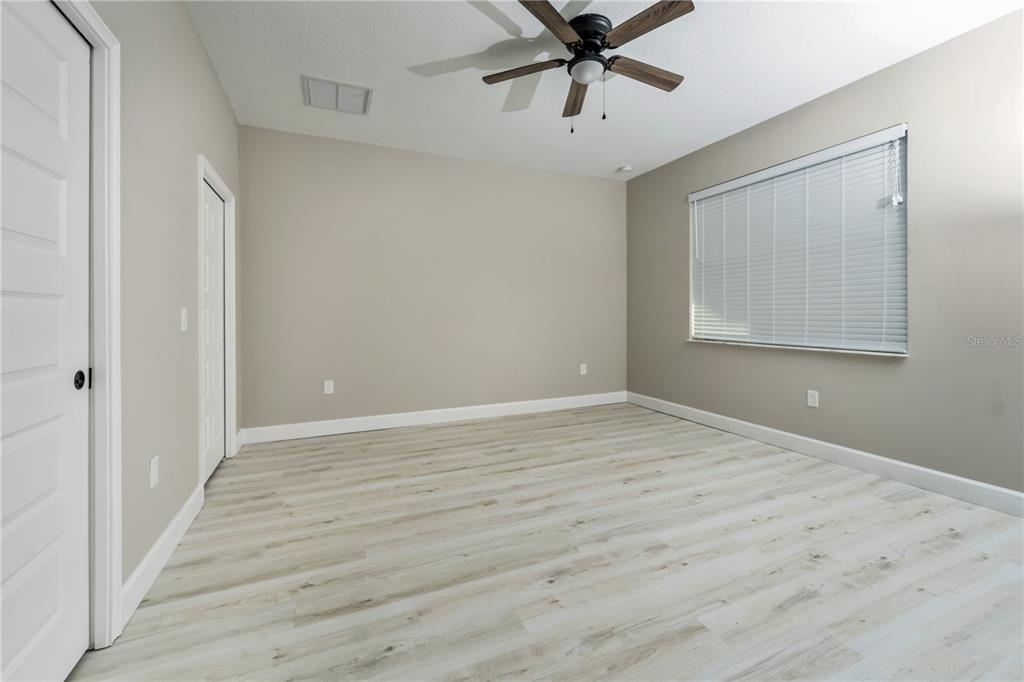 1011 Johnston Road Southeast Palm Bay, FL 32909 - Photo 23 of 47 a view of an empty room with a window and wooden floor