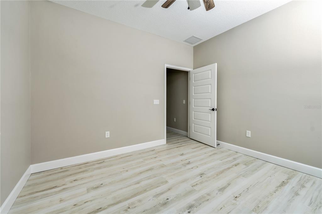 1011 Johnston Road Southeast Palm Bay, FL 32909 - Photo 24 of 47 a view of an empty room with wooden floor