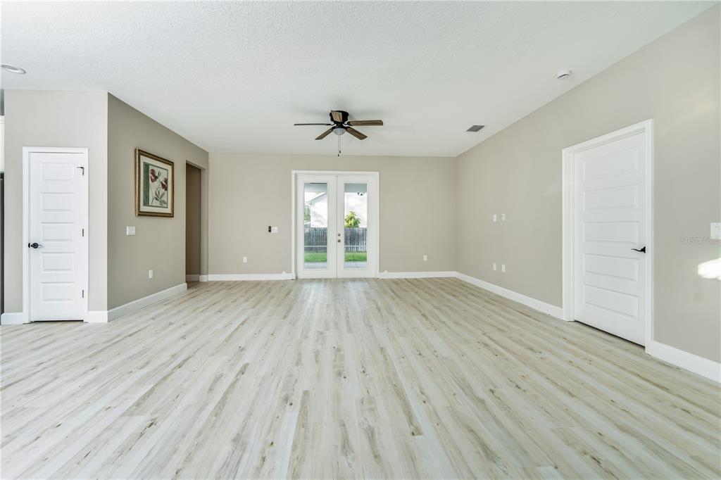 1011 Johnston Road Southeast Palm Bay, FL 32909 - Photo 3 of 47 wooden floor in an empty room with a window