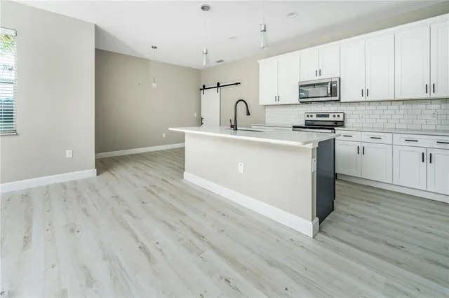 a kitchen with a sink stove and microwave