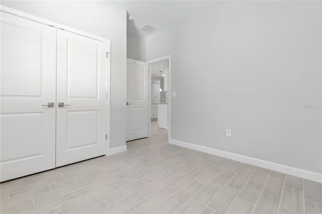 an empty room with wooden floor