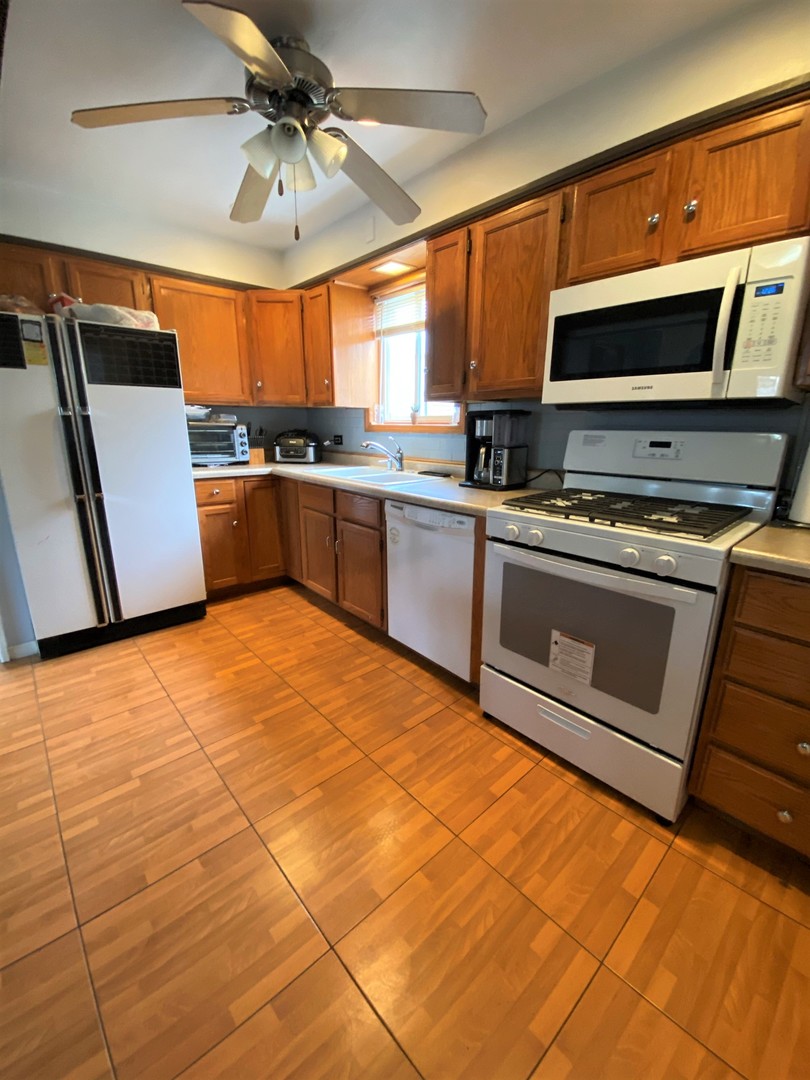 238 North Wolf Road Hillside, IL 60162 - Photo 8 of 17 a kitchen with stainless steel appliances a stove a microwave and a sink