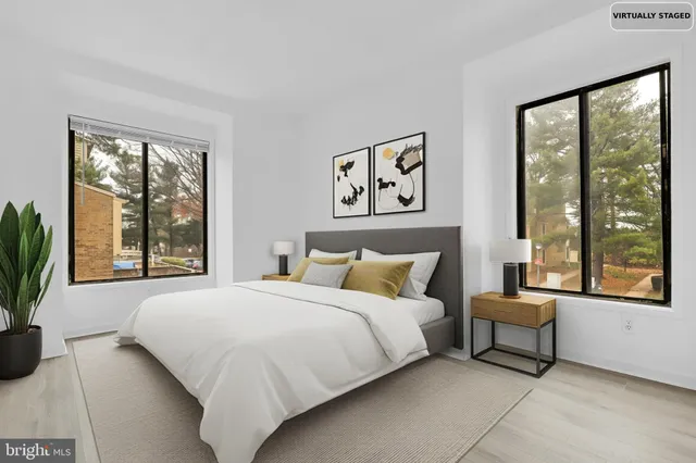 a bedroom with a bed and a large window