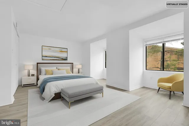 a bedroom with a bed and a large window