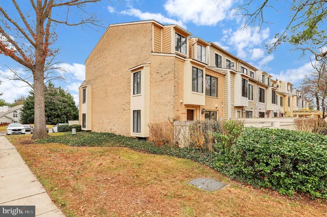 a view of a white house with a yard