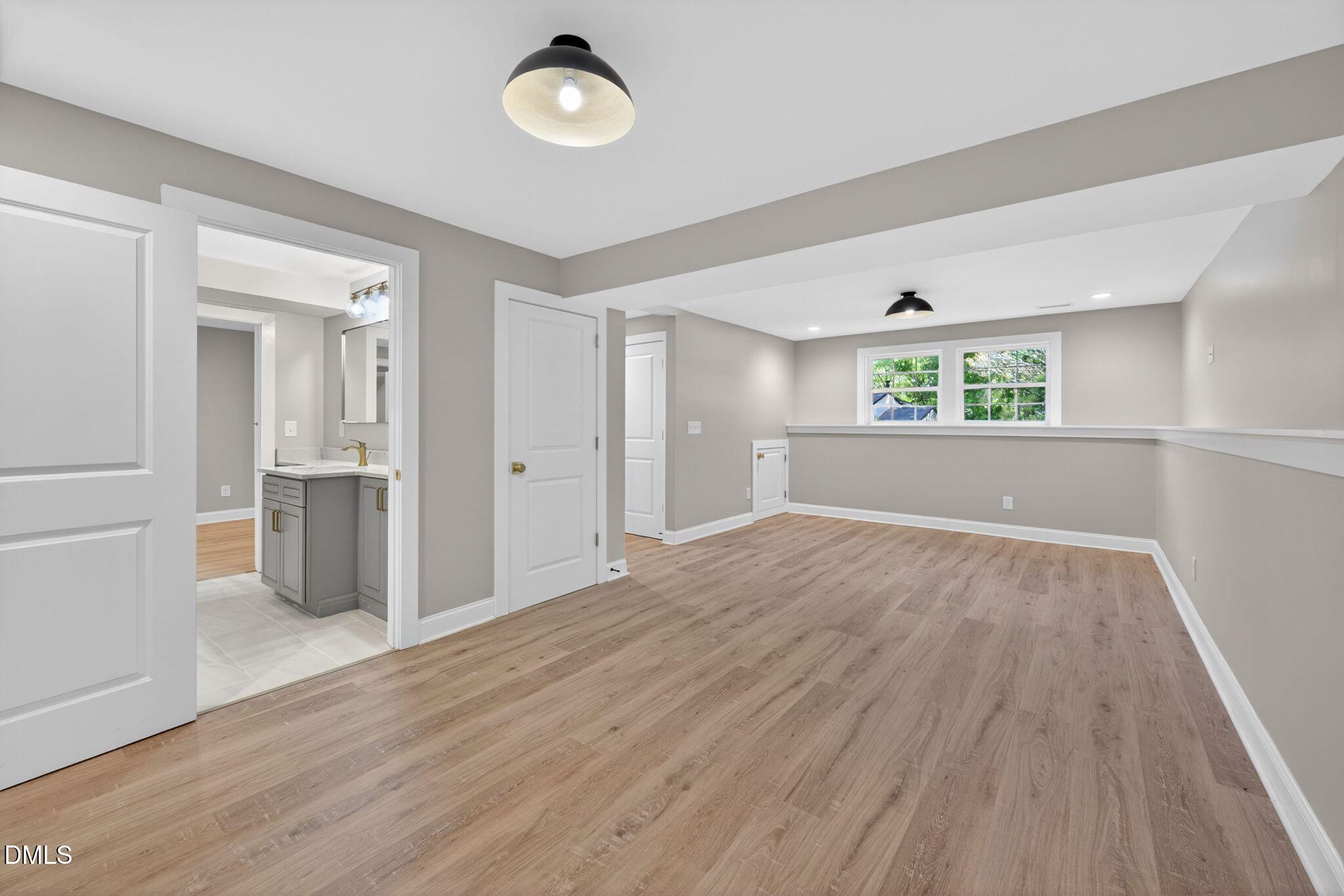 313 Crown Oaks Drive Raleigh, NC 27615 - Photo 59 of 60 an empty room with wooden floor and windows