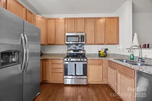 a kitchen with a refrigerator stove and sink