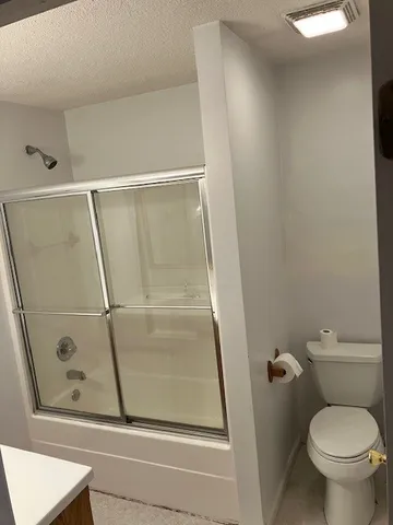 a bathroom with a shower and toilet