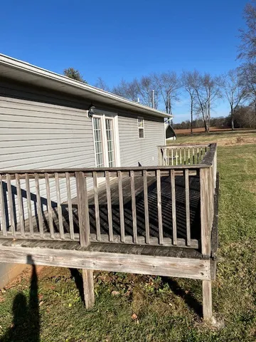 a view of a house with wooden fence