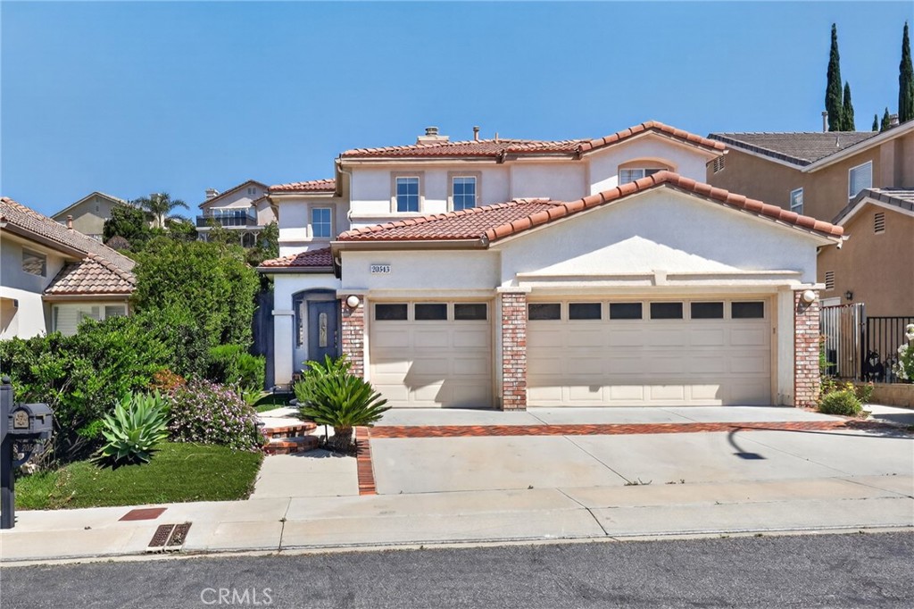20543 Pesaro Porter Ranch Porter Ranch, CA 91326 - Photo 2 of 67 front view of a house with a small yard