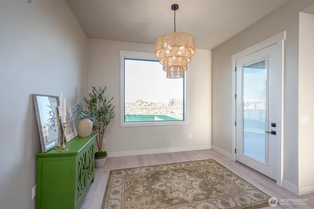 a view of large kitchen with large windows and wooden floor