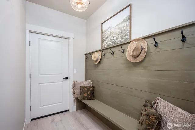 an empty room with windows fireplace and wooden floor