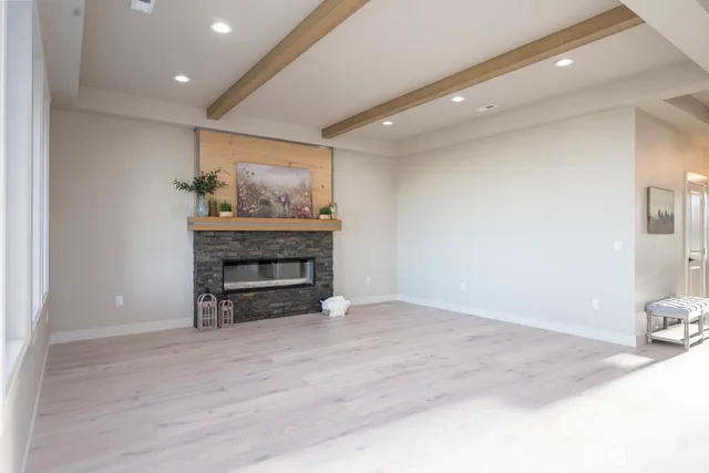 a bathroom with a granite countertop sink a mirror and a shower