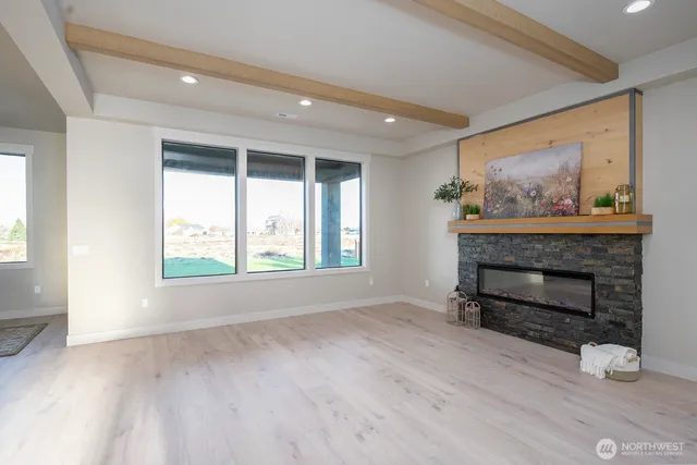 a spacious bathroom with a granite countertop sink a toilet a mirror and vanity