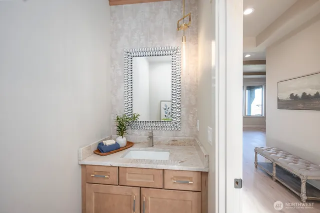 an empty room with a chandelier fan and windows