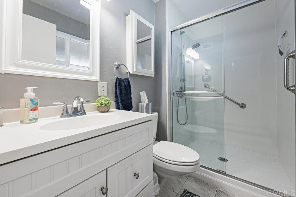 8450 Carlton Oaks Drive Santee, CA 92071 - Photo 19 of 30 a bathroom with a sink a toilet and shower
