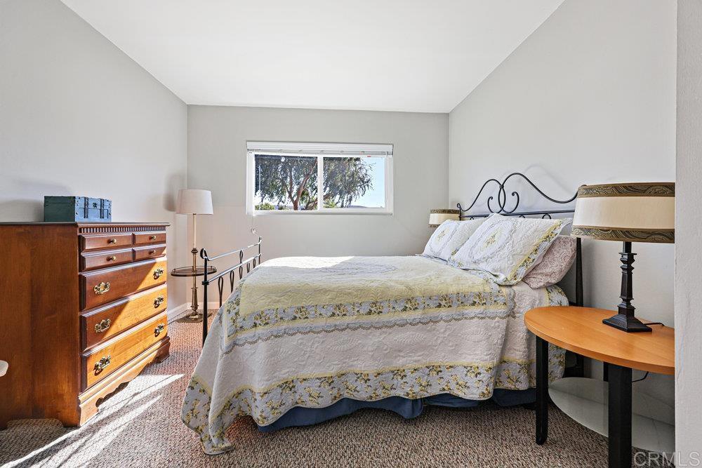 8450 Carlton Oaks Drive Santee, CA 92071 - Photo 21 of 30 a bedroom with a bed and a lamp on dresser