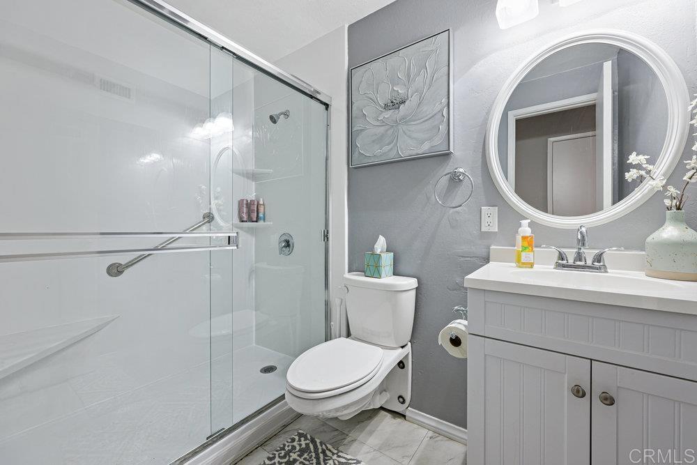 8450 Carlton Oaks Drive Santee, CA 92071 - Photo 22 of 30 a bathroom with a toilet sink and mirror