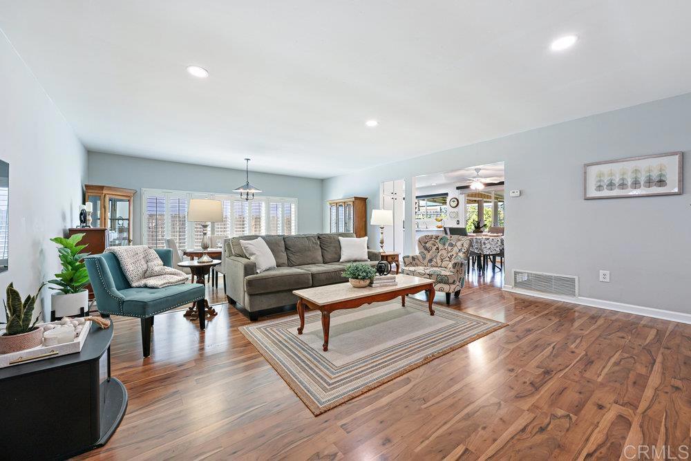 8450 Carlton Oaks Drive Santee, CA 92071 - Photo 7 of 30 a living room with furniture a wooden floor and a potted plant