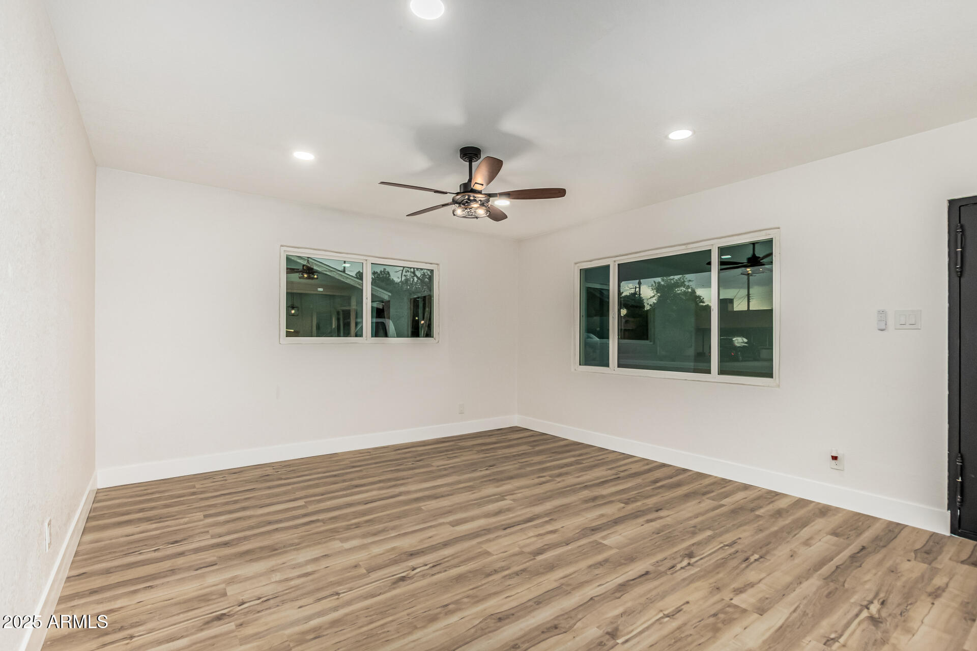 3111 North 34th Street Phoenix, AZ 85018 - Photo 11 of 76 a view of a livingroom with a ceiling fan and wooden floor