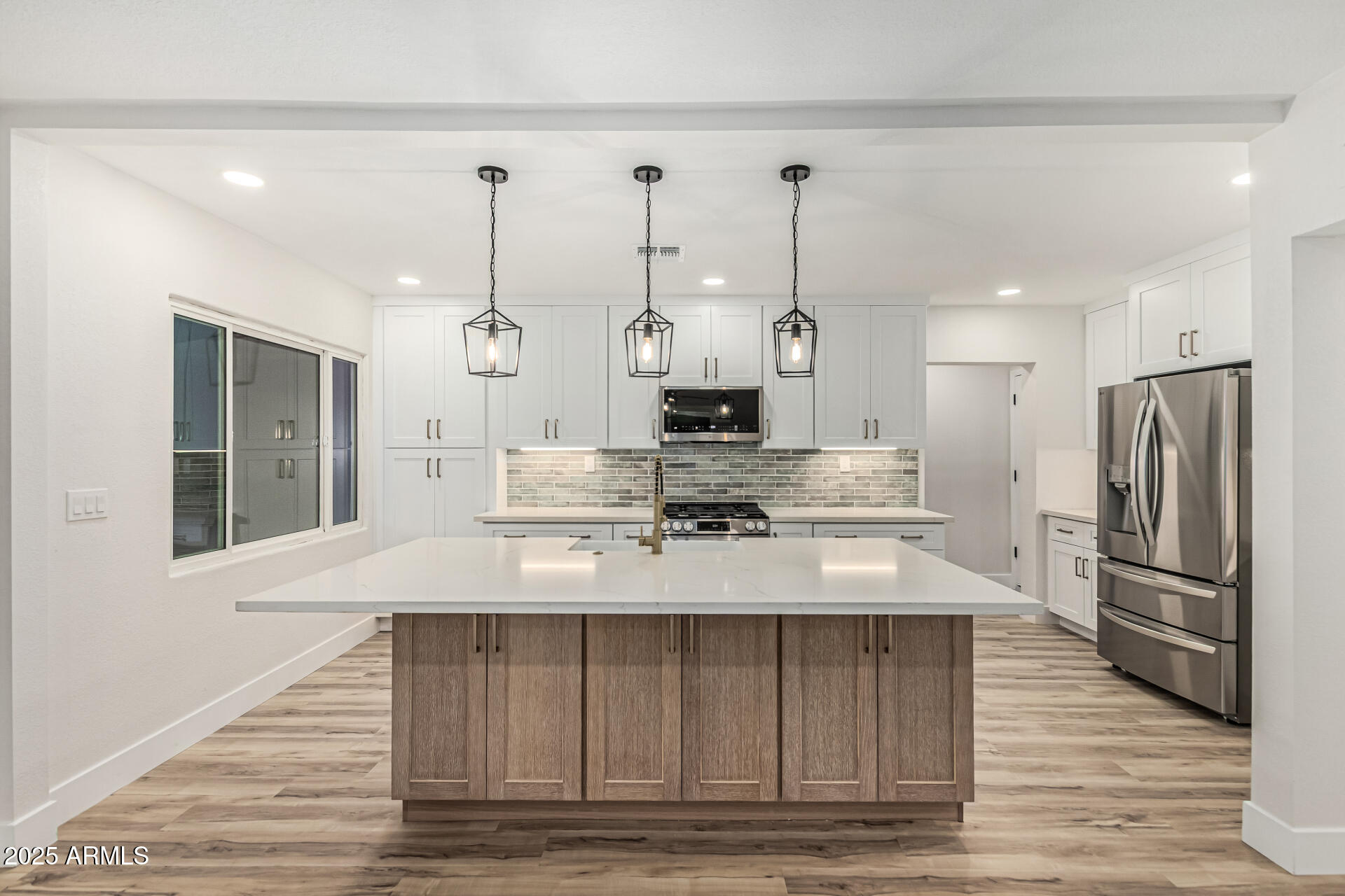 3111 North 34th Street Phoenix, AZ 85018 - Photo 14 of 76 a large kitchen with stainless steel appliances kitchen island granite countertop a refrigerator a stove and a wooden floors