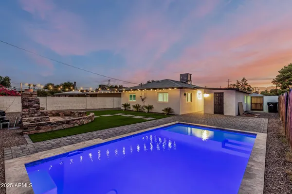 a swimming pool with lawn chairs and outdoor view