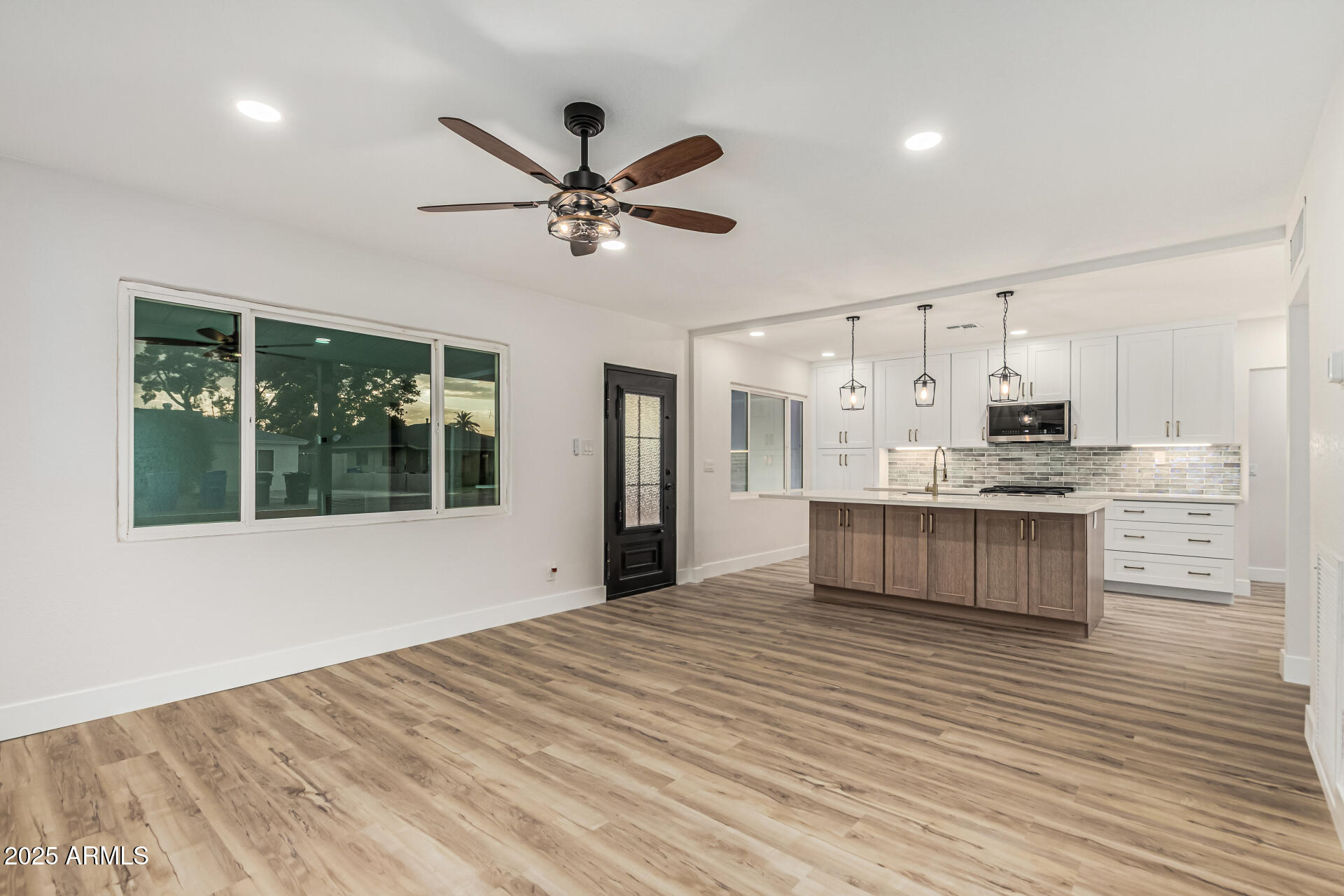 3111 North 34th Street Phoenix, AZ 85018 - Photo 22 of 76 a large white kitchen with kitchen island white cabinets and stainless steel appliances