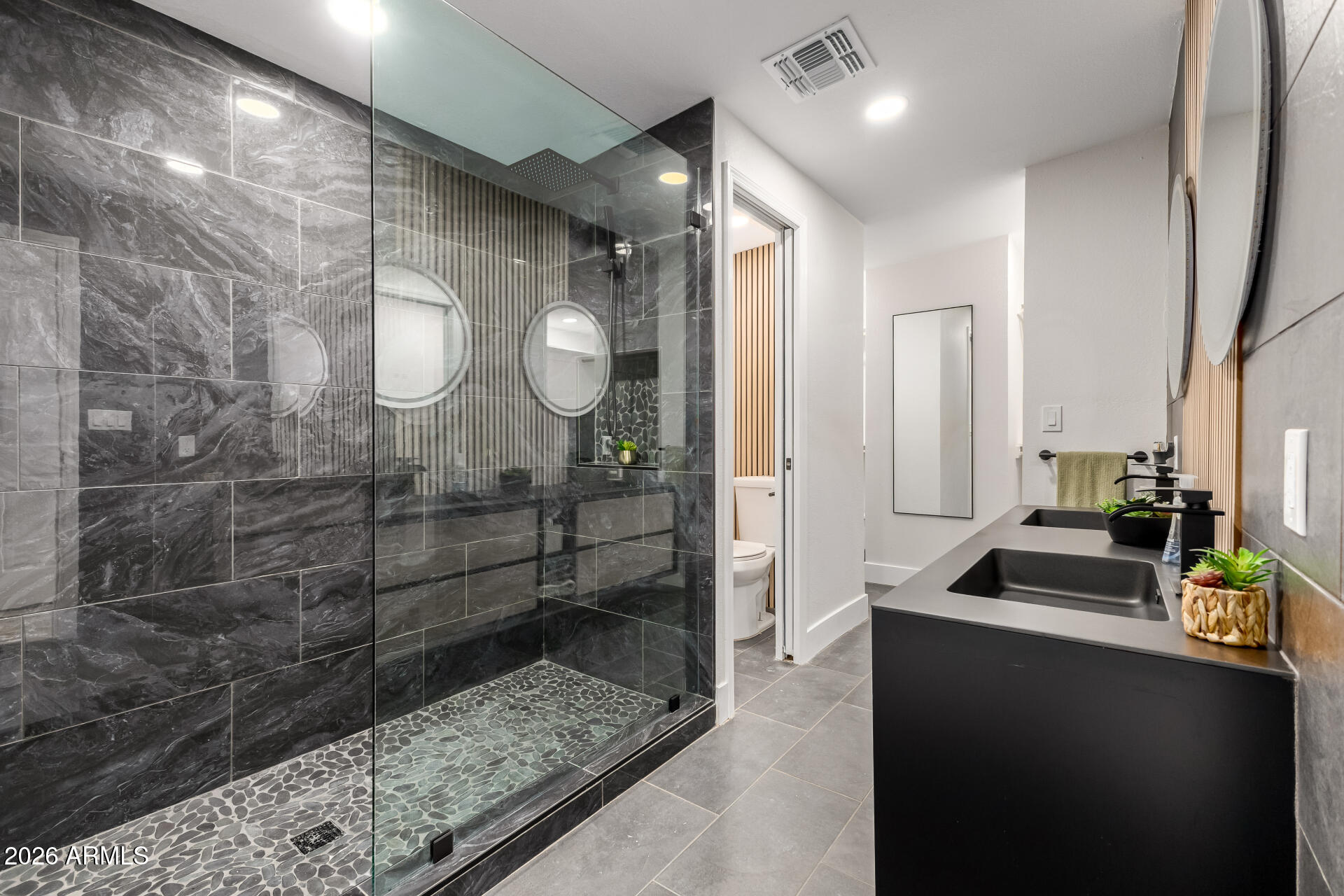 3111 North 34th Street Phoenix, AZ 85018 - Photo 28 of 76 a bathroom with a sink a toilet and a shower