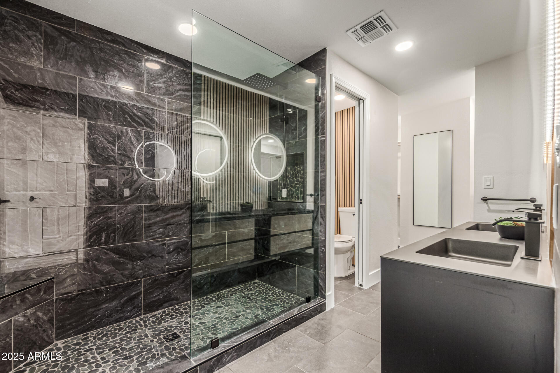 3111 North 34th Street Phoenix, AZ 85018 - Photo 29 of 76 a bathroom with a mirror and a shower