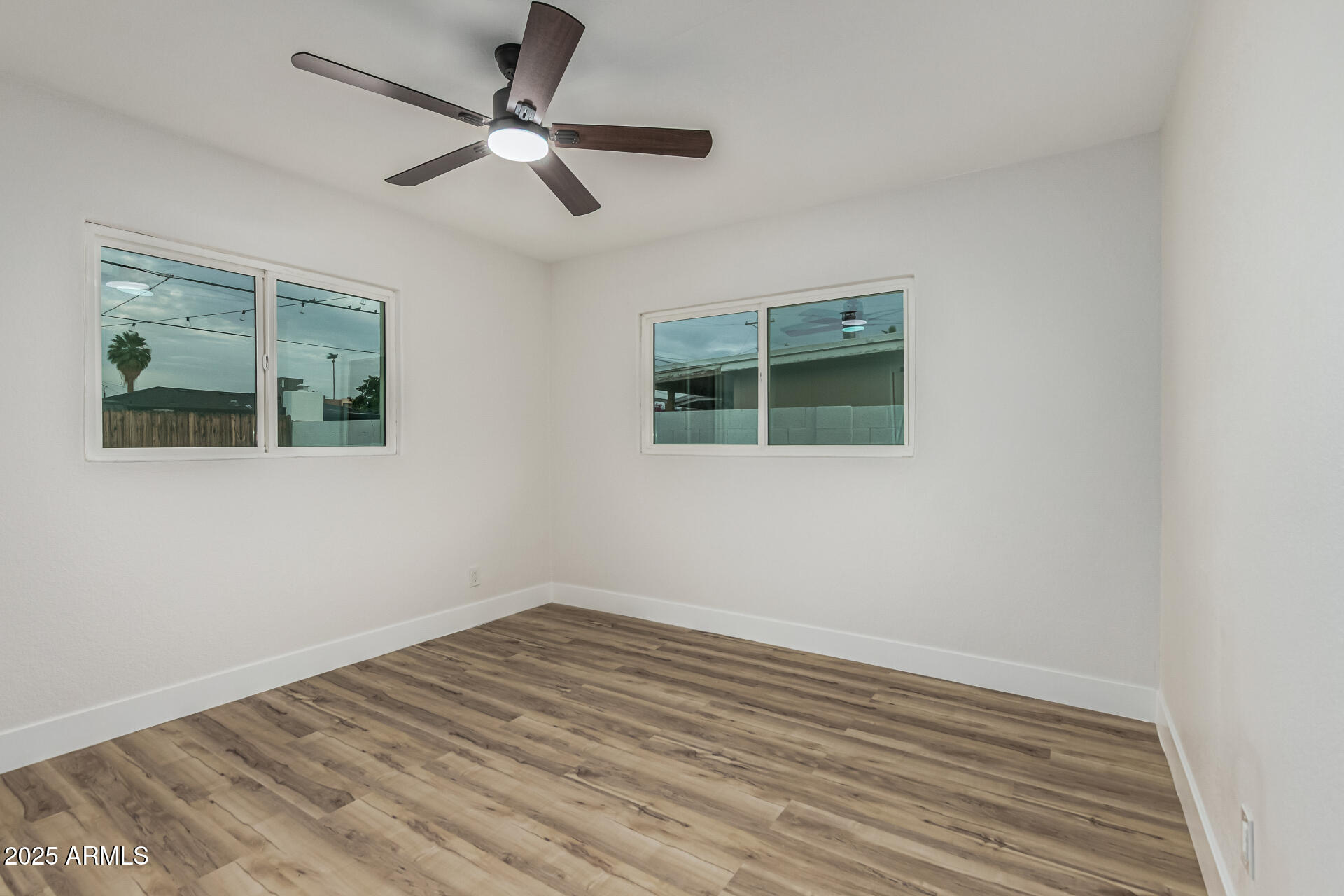 3111 North 34th Street Phoenix, AZ 85018 - Photo 57 of 76 an empty room with wooden floor and windows