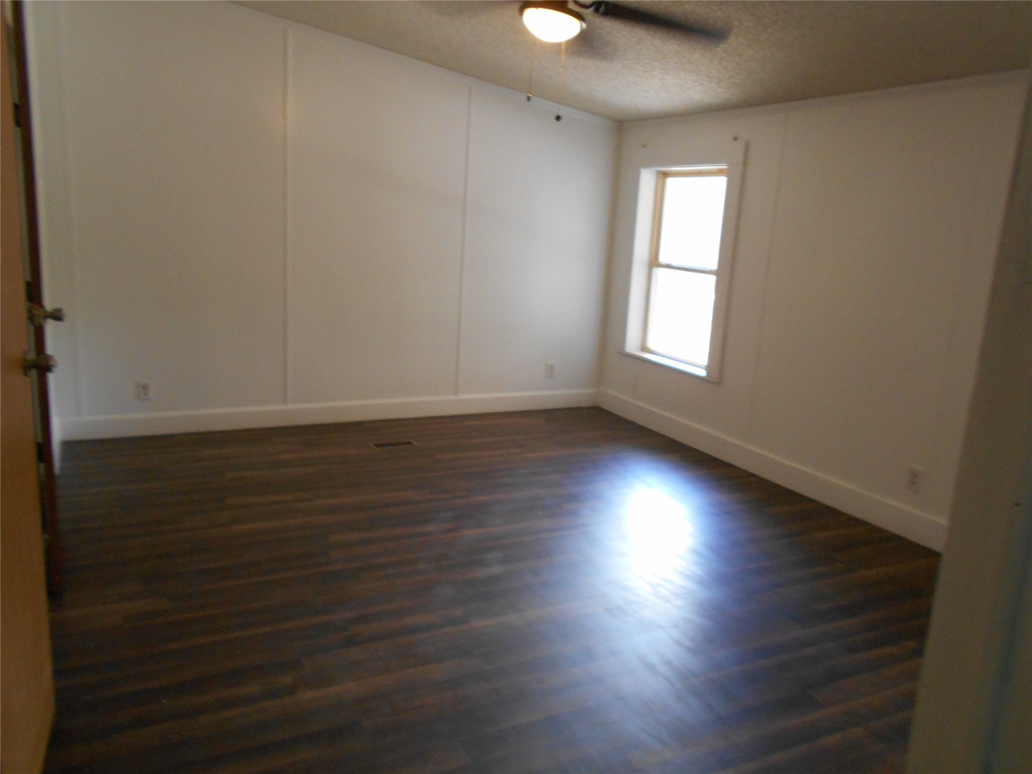 8001 Burleson Manor Road Manor, TX 78653 - Photo 17 of 31 A well-lit bedroom with rich wood flooring awaits your personal touch.