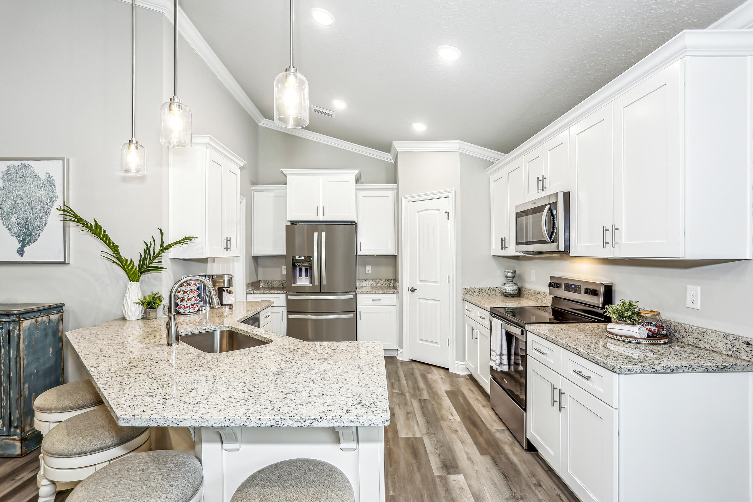 3494 Doyle Hawkins Road Navarre, FL 32566 - Photo 13 of 31 a kitchen with stainless steel appliances granite countertop a kitchen island hardwood floor sink stove and microwave