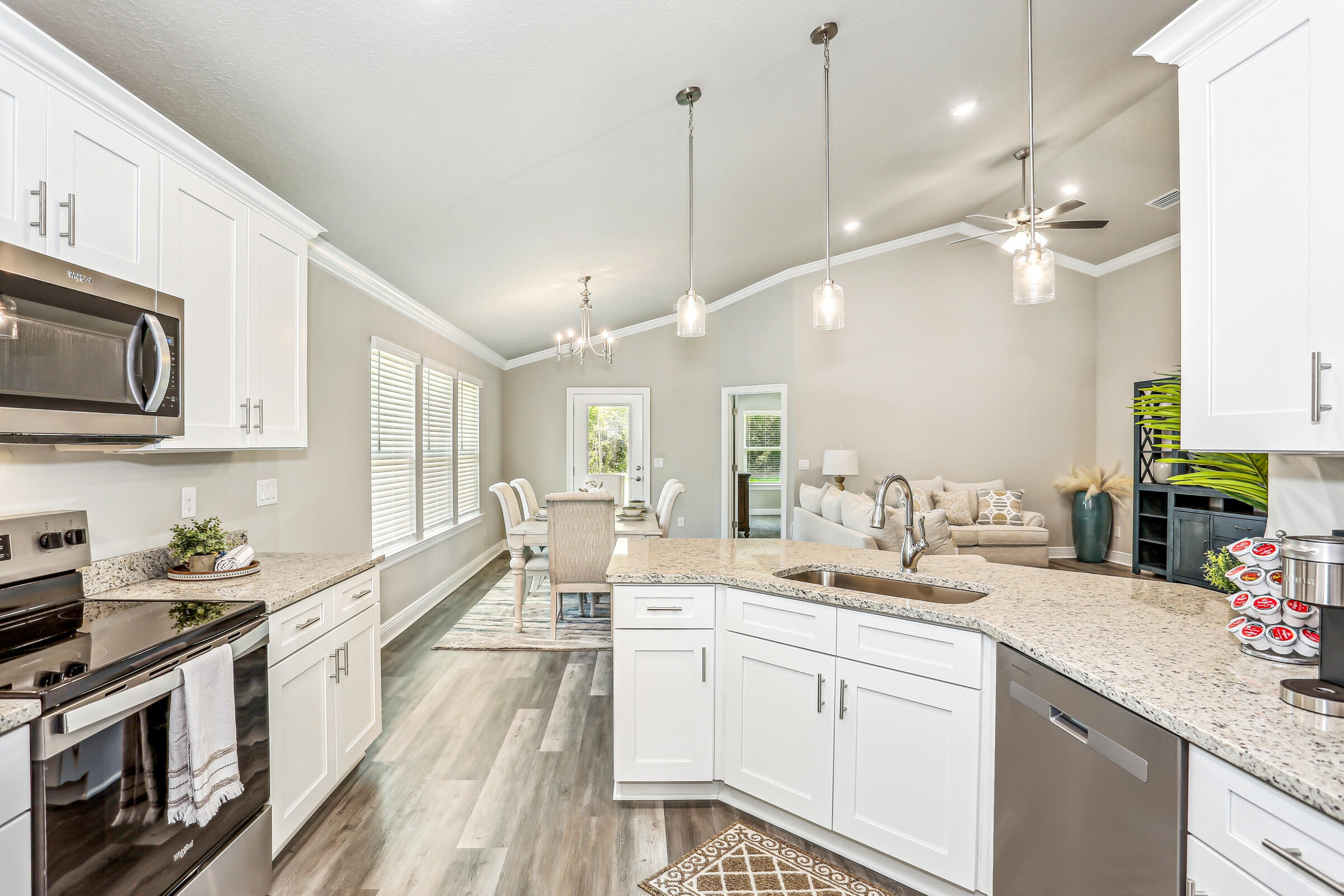 3494 Doyle Hawkins Road Navarre, FL 32566 - Photo 16 of 31 a large white kitchen with lots of counter space a sink and appliances