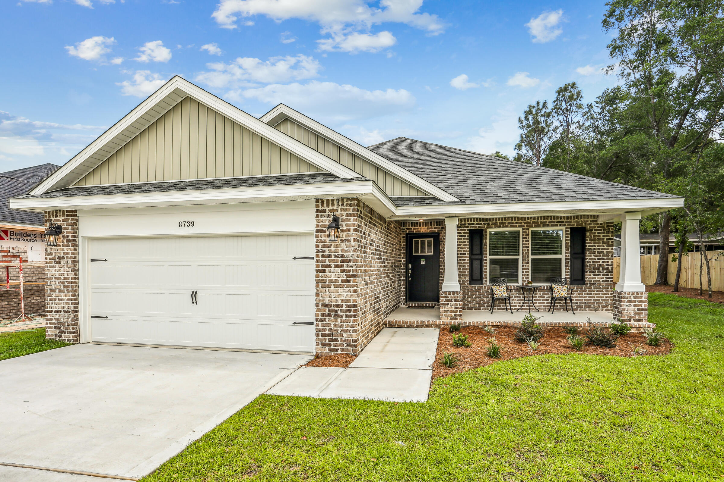 3494 Doyle Hawkins Road Navarre, FL 32566 - Photo 2 of 31 a front view of a house with yard outdoor seating and garage