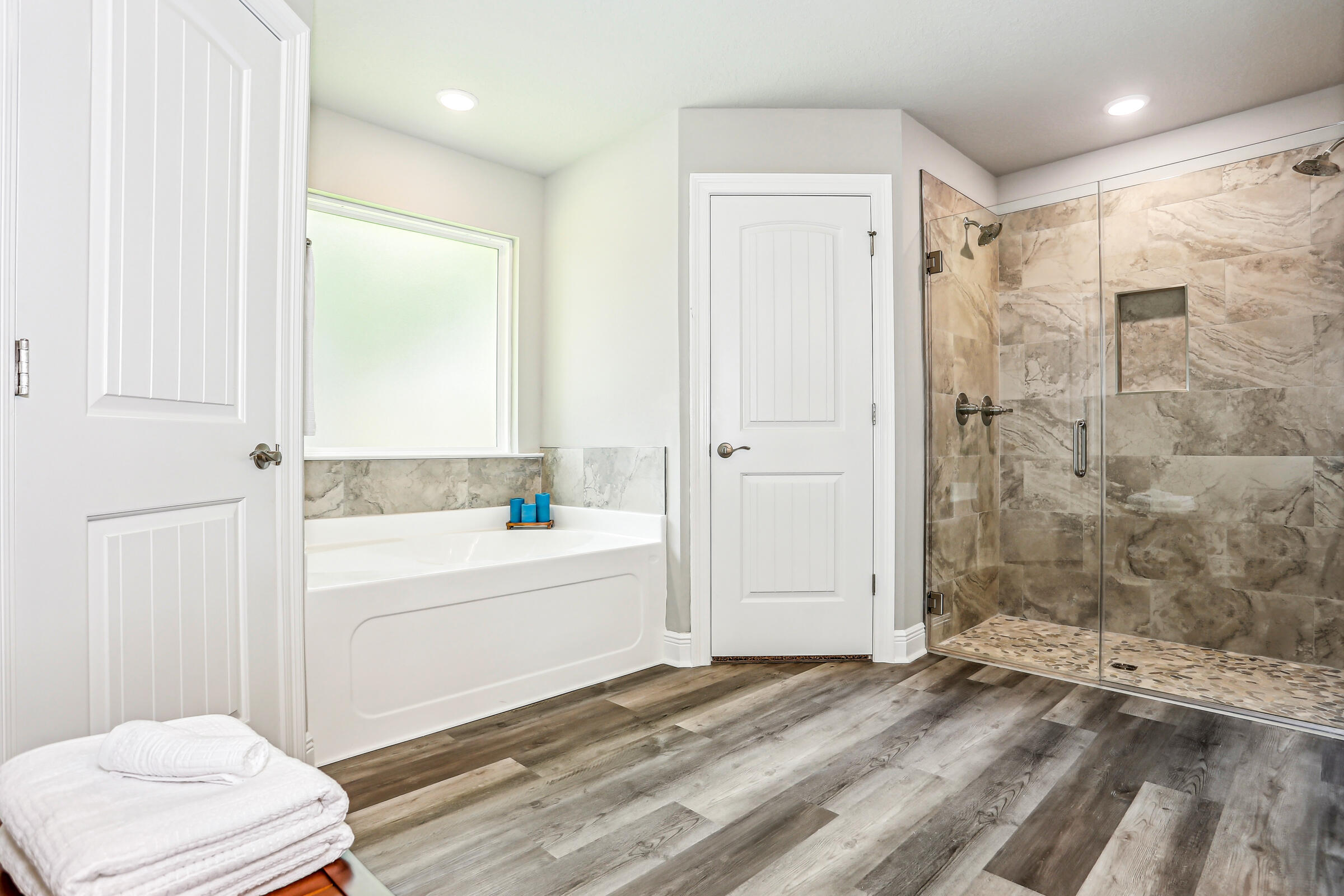 3494 Doyle Hawkins Road Navarre, FL 32566 - Photo 21 of 31 a bathroom with a bathtub and a shower