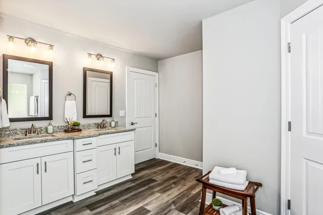 a bathroom with a double vanity sink and a mirror