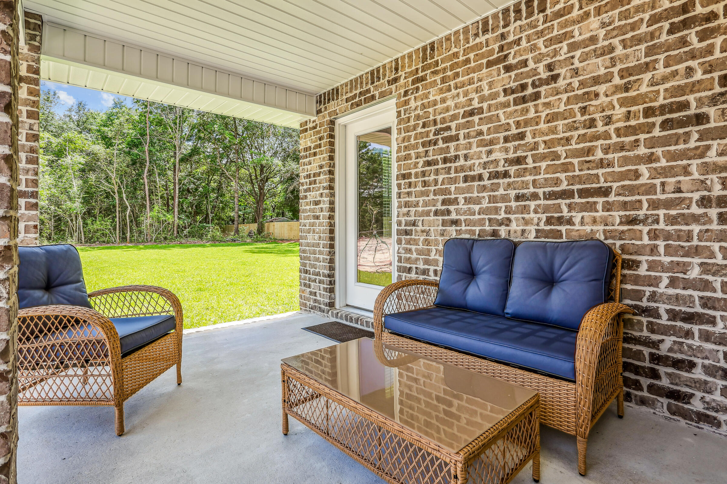3494 Doyle Hawkins Road Navarre, FL 32566 - Photo 30 of 31 a outdoor living space with furniture and a garden