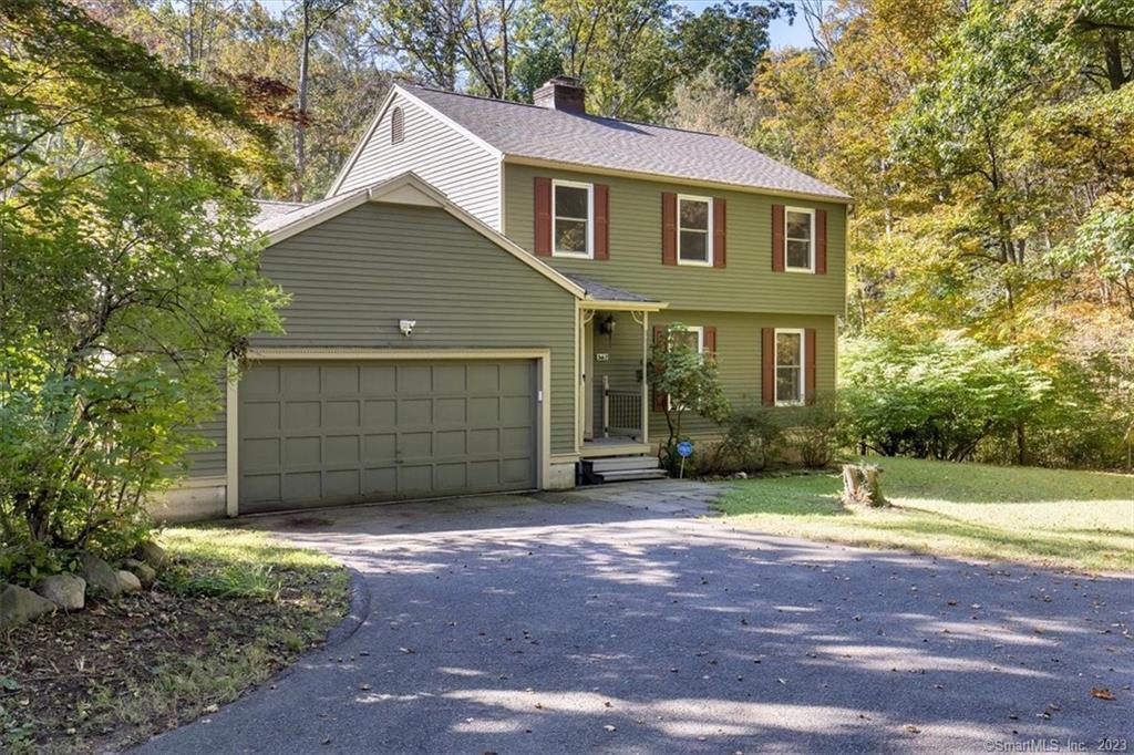 362 Racebrook Road Orange, CT 06477 - Photo 1 of 1 a front view of a house with a yard and garage