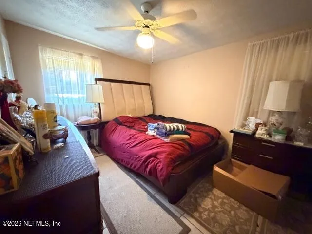 a bedroom with a bed furniture and a window