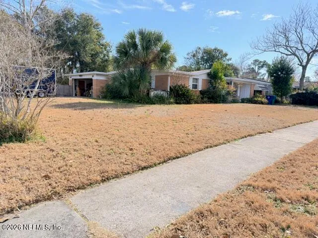 a view of white house with a yard