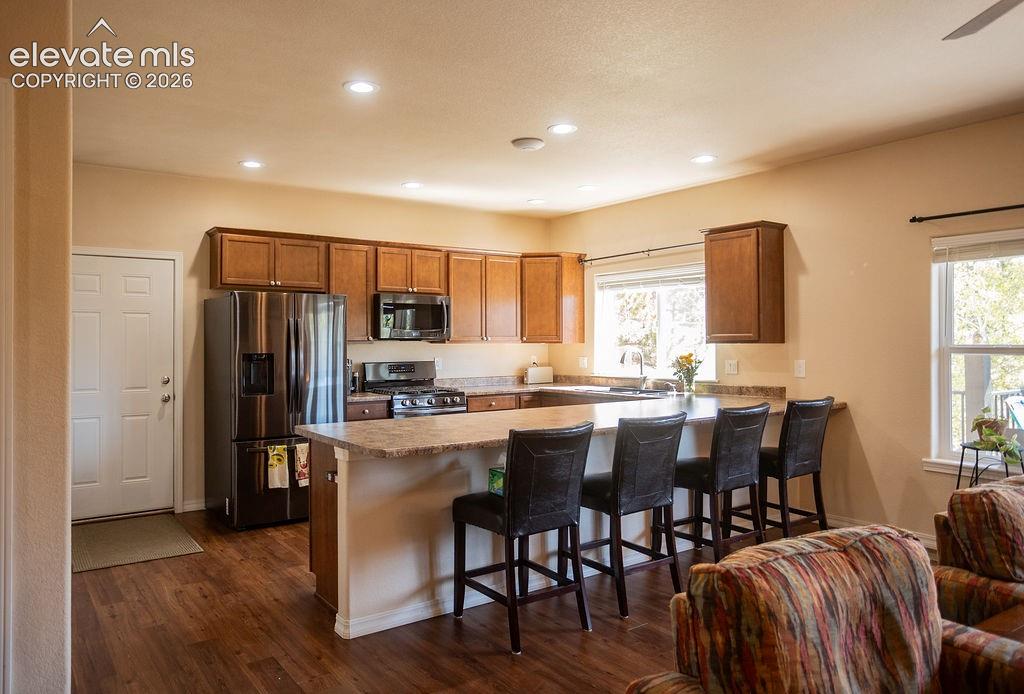45 Valley Circle Divide, CO 80814 - Photo 8 of 42 a kitchen with stainless steel appliances a dining table chairs and wooden floor