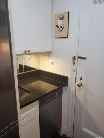a kitchen with a sink and a refrigerator